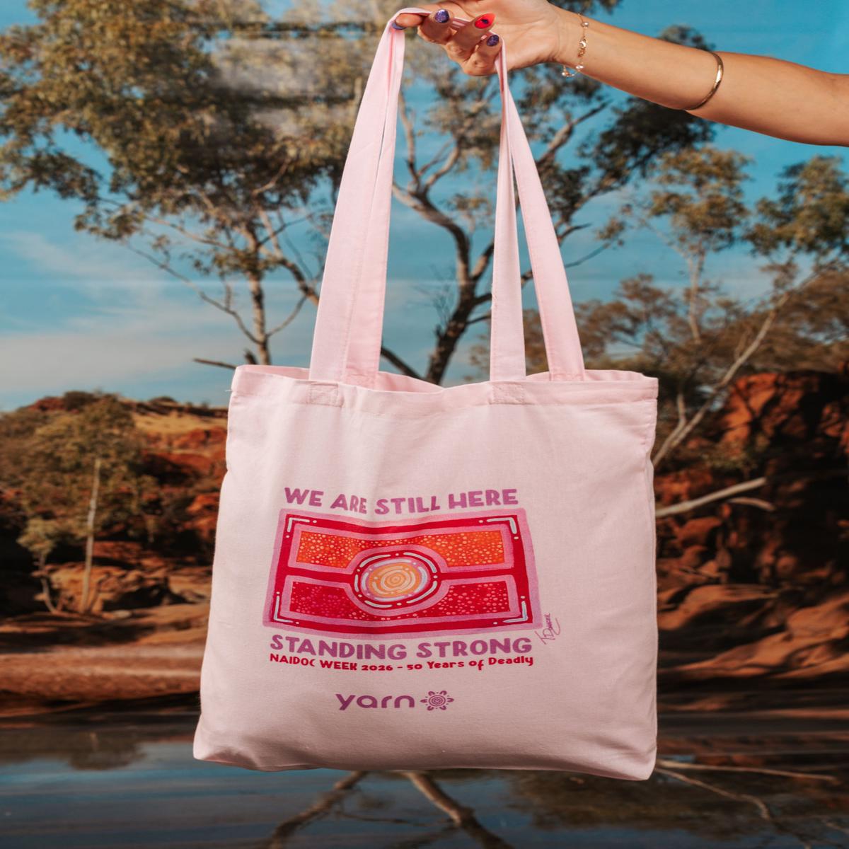 We Are Still Here NAIDOC Week 2026 Tote Bag Pink Long Handle Cotton Tote Bag